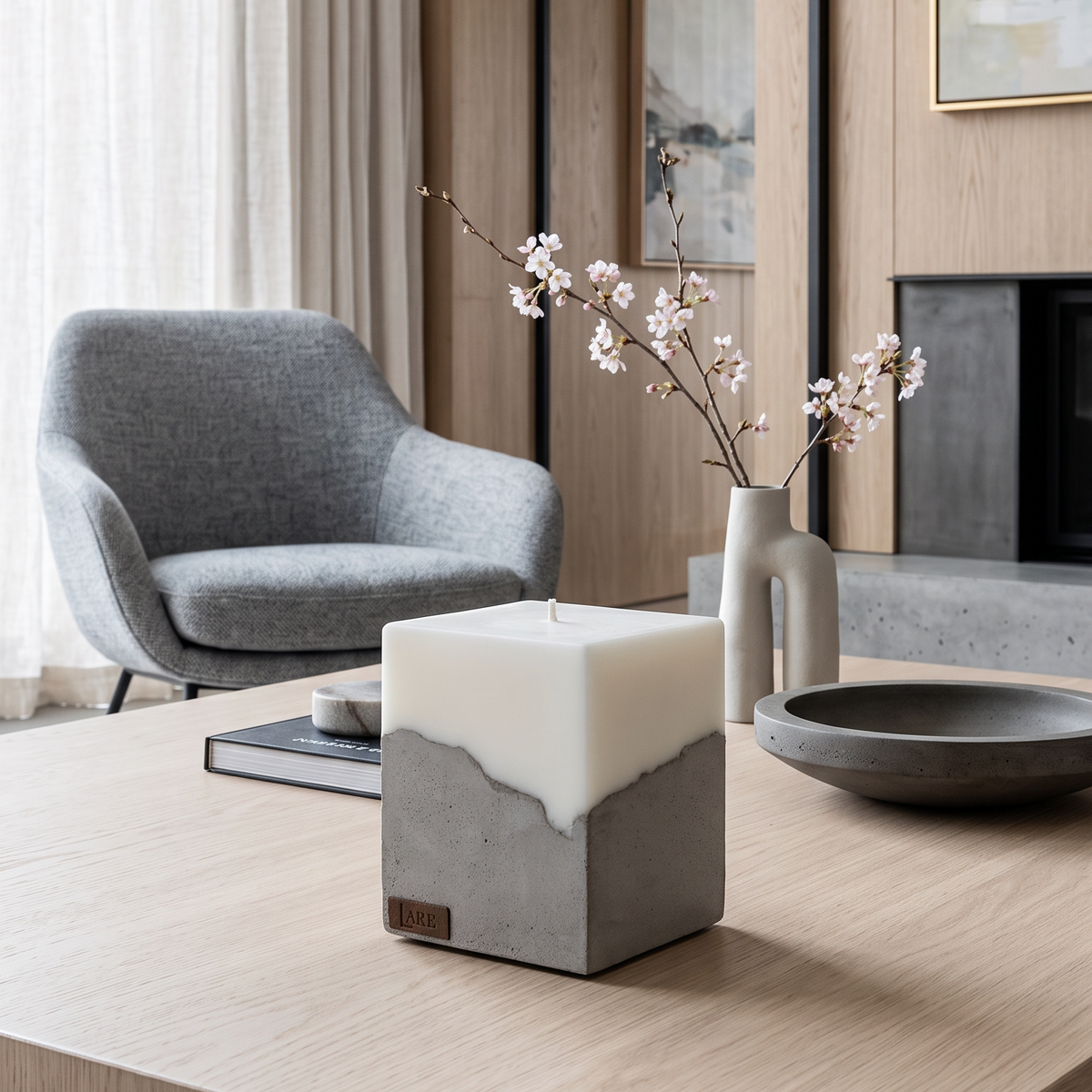 LARE Studio sculptural candle design featured among the best candle brands, with a minimalist grey concrete base and premium scented soy wax, styled on a wooden coffee table.