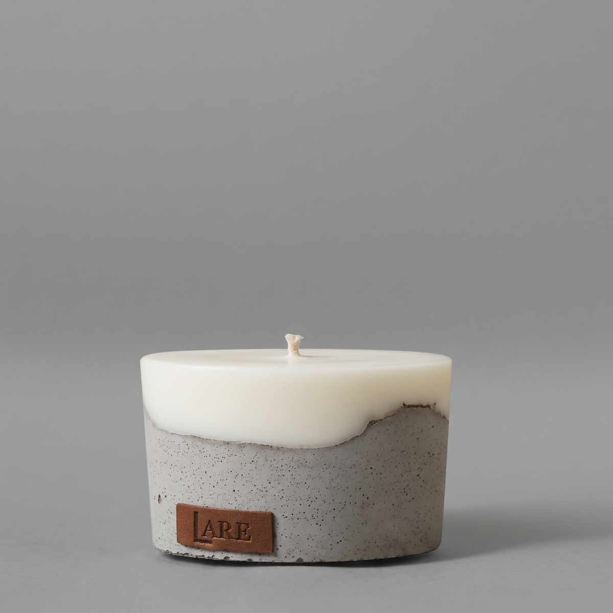 Premium soy blend candle with a natural cotton wick in a grey concrete base
