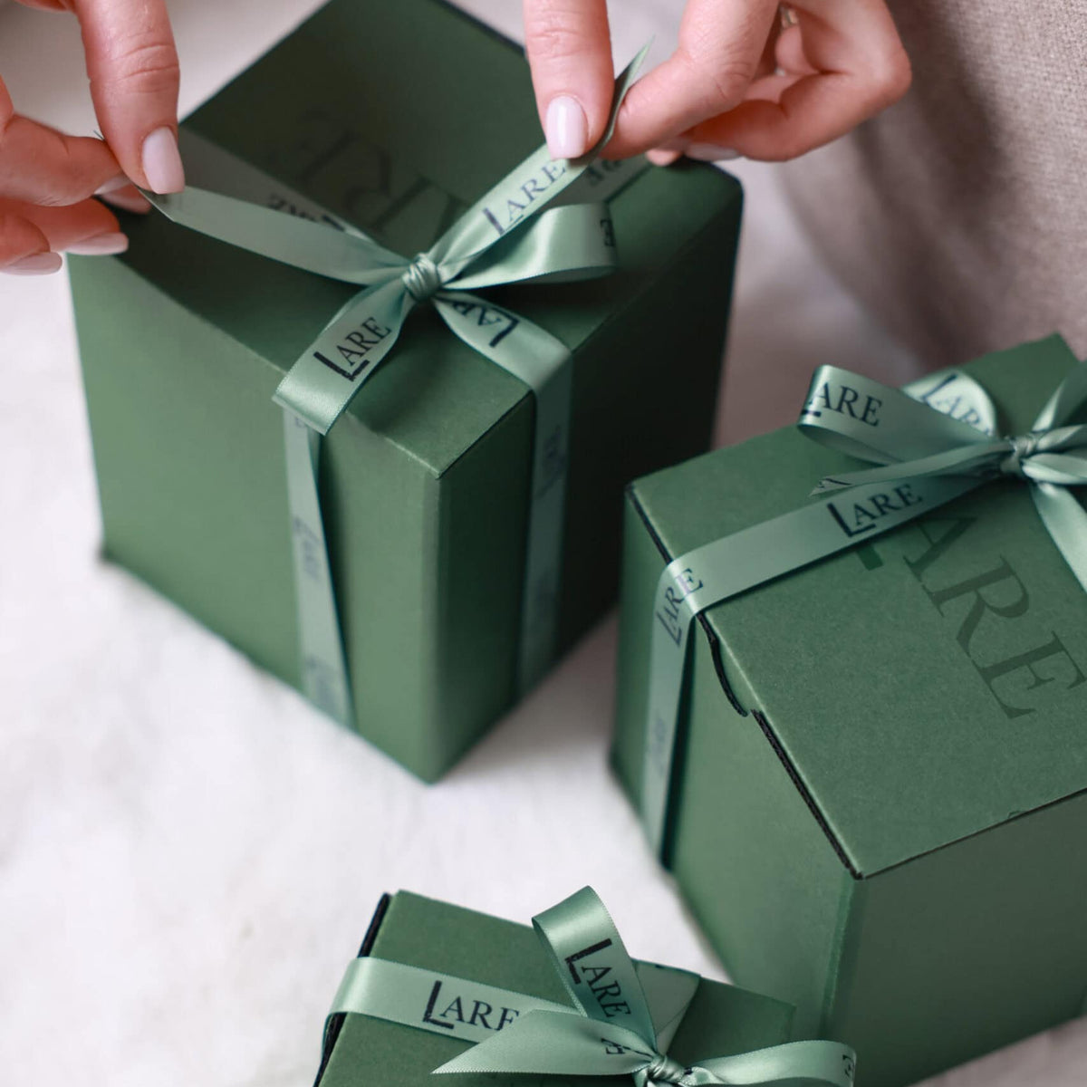 LARE Studio premium gift box opening to reveal a luxury scented soy candle.