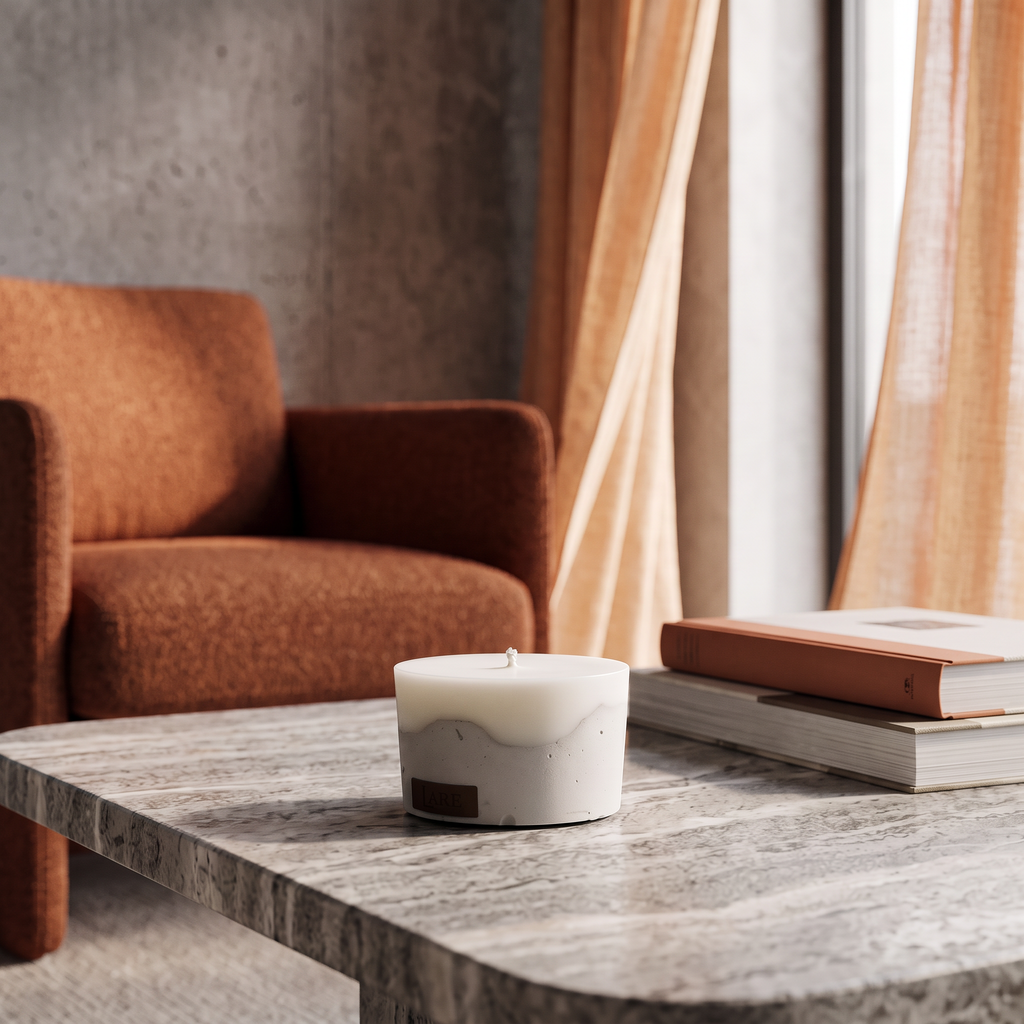 Aesthetic concrete soy blend candle with a natural cotton wick sitting on a luxury marble coffee table in a modern living room