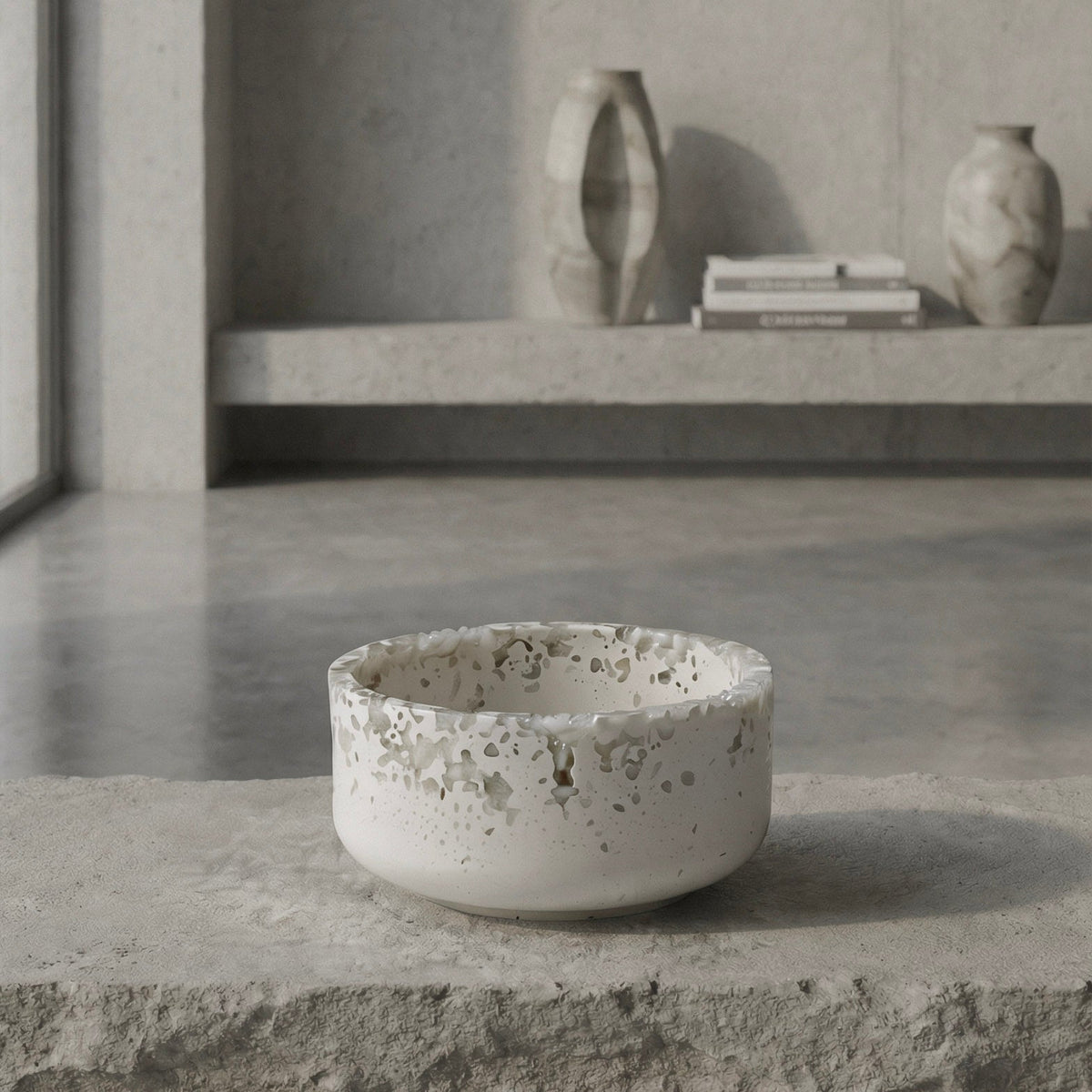 Mineral resin bowl on a concrete surface with a minimalistic background