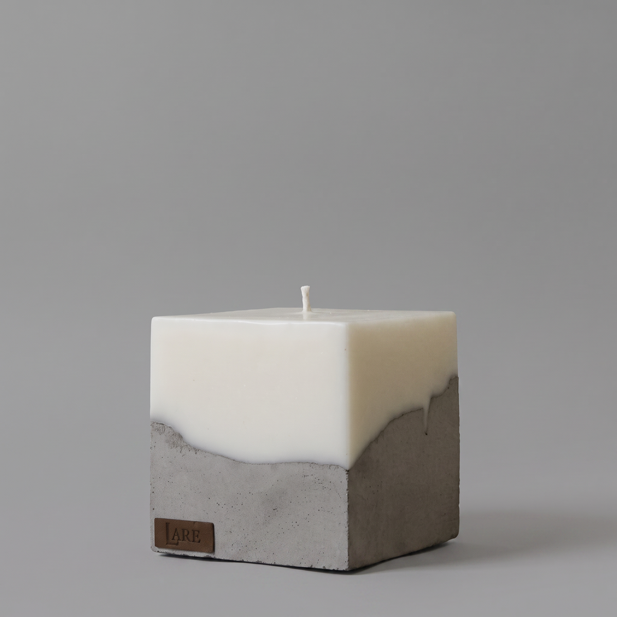 LARE Studio sculptural soy candle with a warm vanilla-sandalwood scent, featured among luxury and wood scented candles on a minimalist grey background.