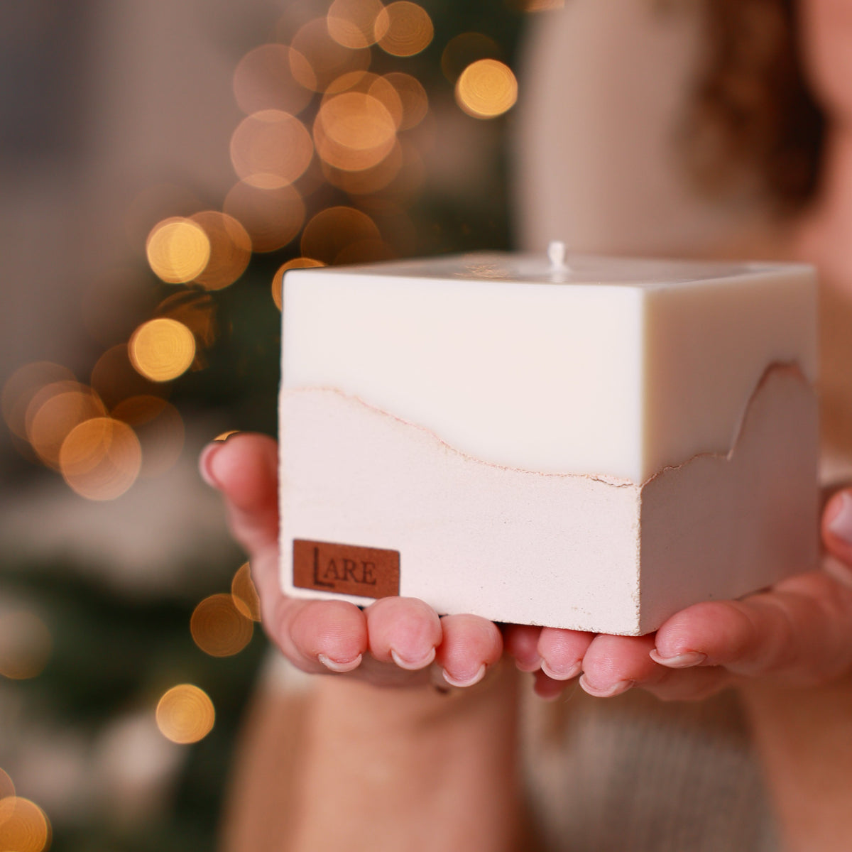 Sculptural beige candle by LARE Studio, featured among premium Christmas candles with festive holiday fragrance notes of cinnamon, orange, and cedar wood