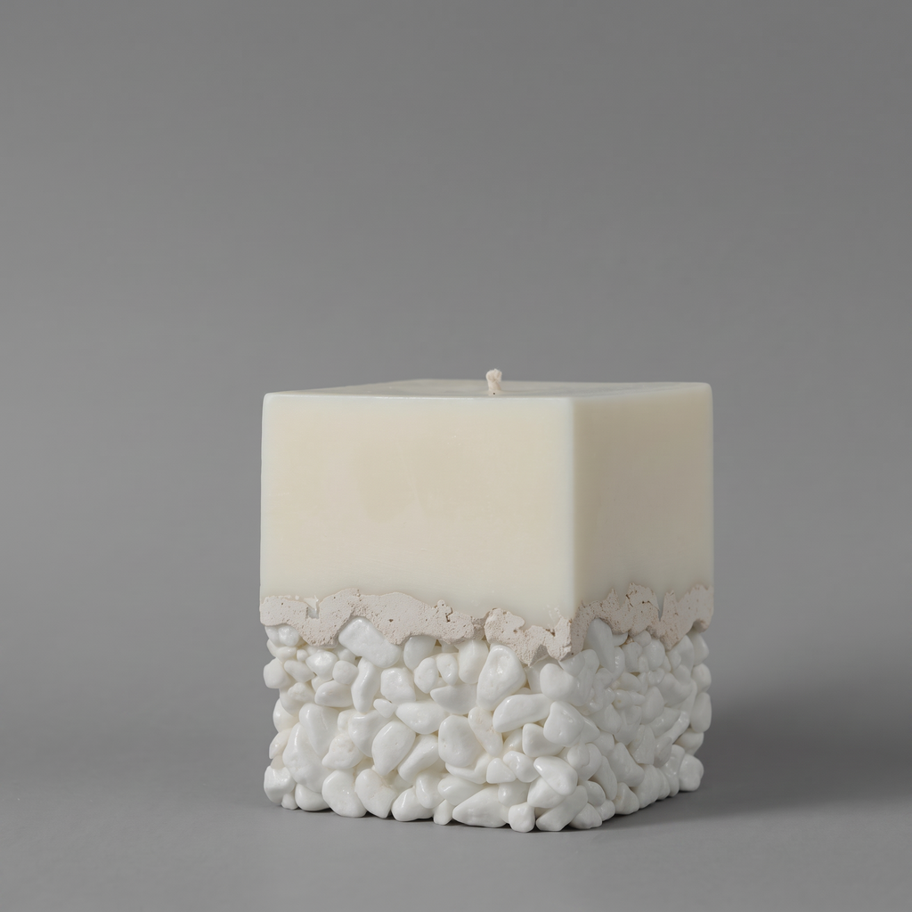 LARE unique candle — white sculptural soy candle wax with pebble and cement base and premium candle scent oil. Photographed against a neutral gray background.
